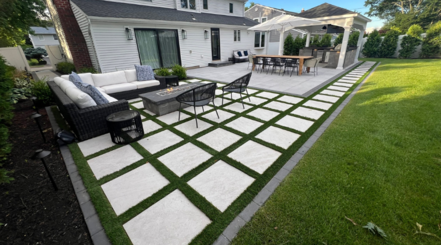 Cambridge paver grid patio with outdoor kitchen, pavilion, fire pit, and lounge zone in Smithtown NY — Flawless Masonry
