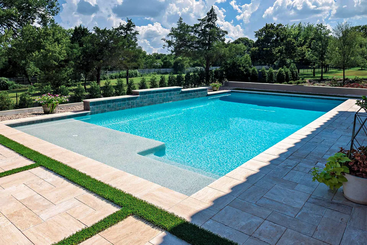 Custom shaped gunite pool with tanning ledge