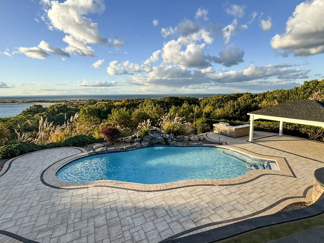 Gunite pool with retaining wall and outdoor living area