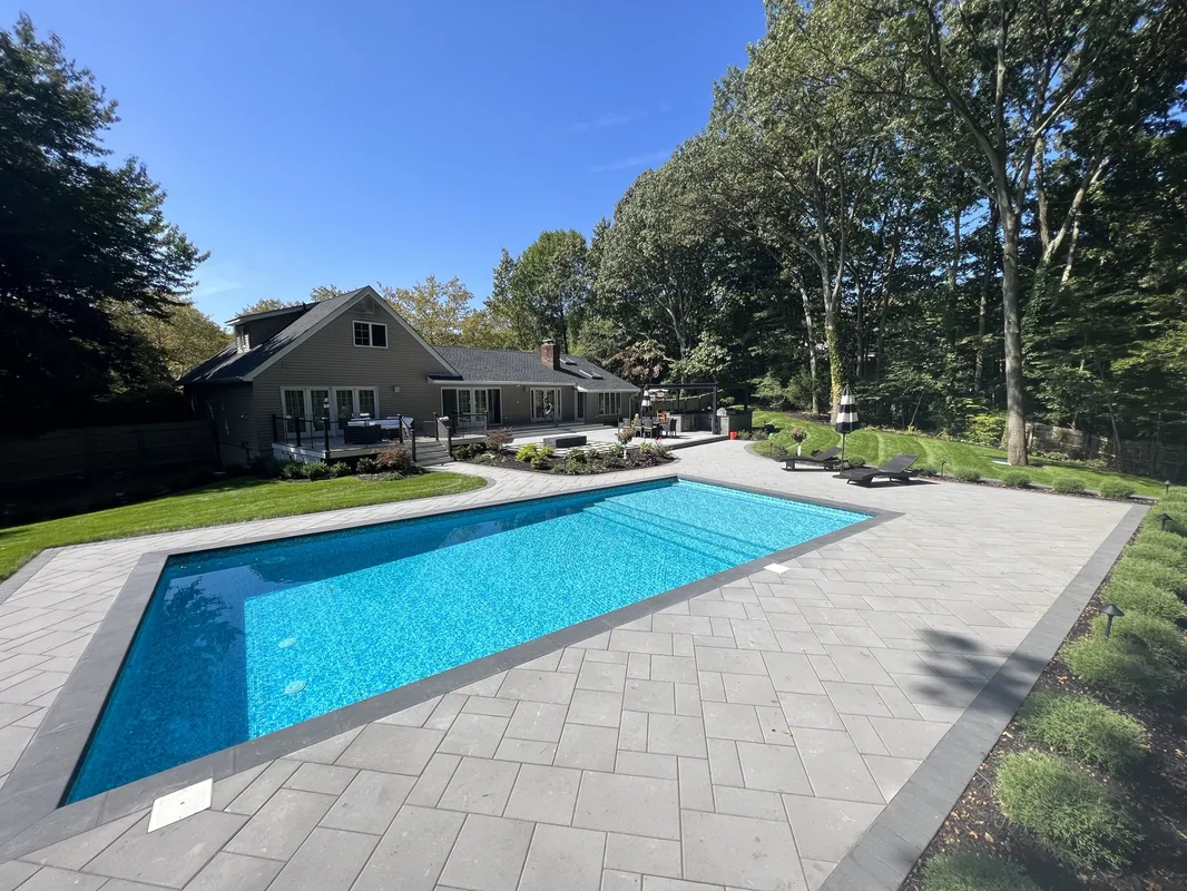 Vinyl pool with stone surround and fire features