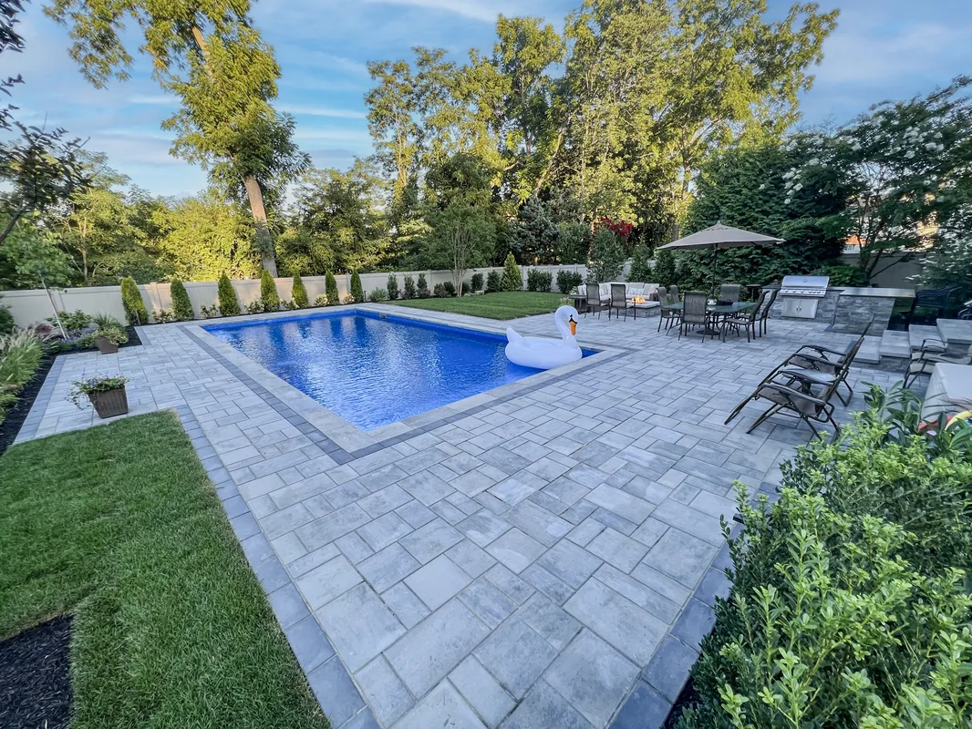 Vinyl pool with paver decking and garden