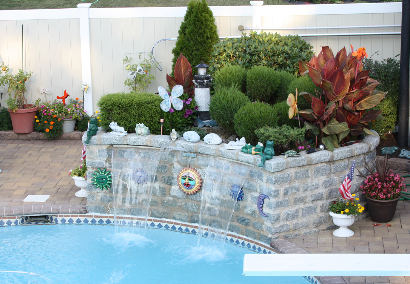 masonry planter with waterfall added to patio and pool 