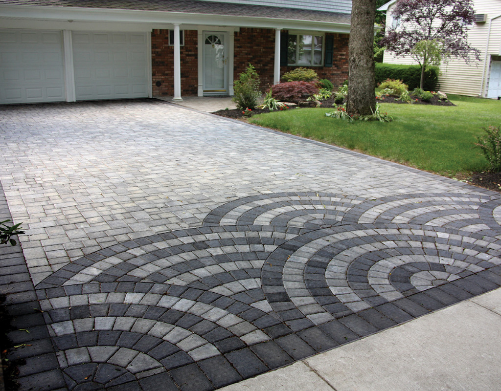 Masonry driveway with scalloped designs on the end of the driveway