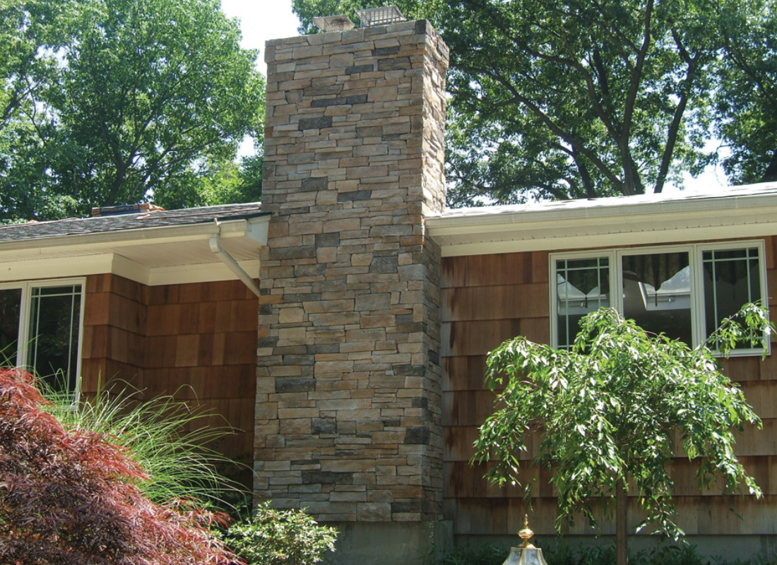Stone chimney on the side of a home