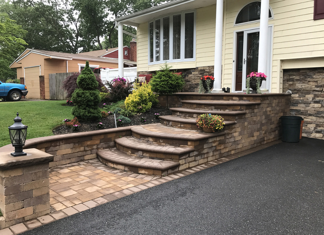 stone stops and steps extending to meet asphalt driveway