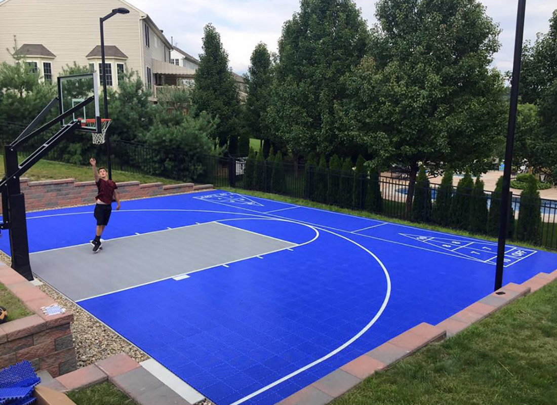 Bright blue half basketball court with shuffle board on the other side
