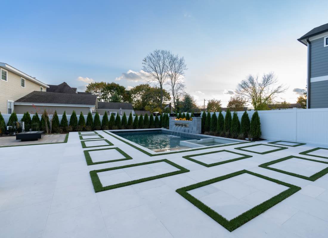 Concrete pool installation Northport — rectangular pool with geometric patio by Flawless Masonry pool installer